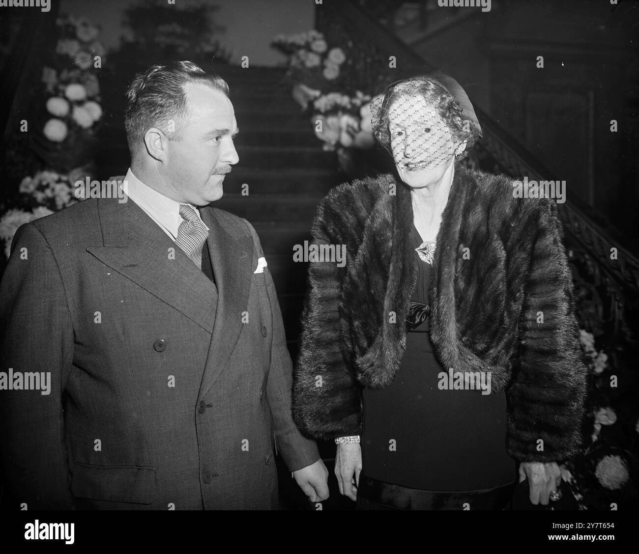 MOTHER OF THE HOSTESS   MRS TURNER , mother of Lady Docker , in Conversation with MAJOR HARRY BARKER at the cocktail party given by Sir Bernard and Lady Docker at the Royal Thames Yacht Club , Hyde Park House , Knightsbridge London , this evening .   14 December 1950 Stock Photo