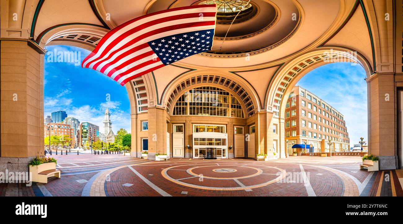 Boston harbor Rowes Wharf passage and cityscape panoramic view, large flag of America, Massachusetts, USA Stock Photo