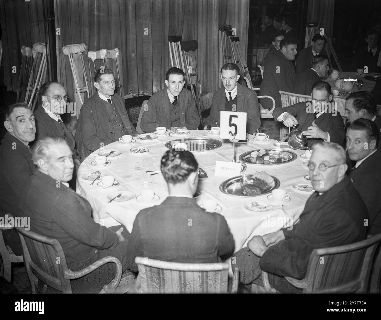 NOT FORGOTTEN” ASSOCIATION ENTERTAINS BRITISH WOUNDED DECEMBER 1944 The Princess Royal was present when the “Not Forgotten” Association entertained British wounded from the Queen Mary Roehampton Hospital at a cabaret tea in the Dorchester Hotel, London, in aid of the Association’s funds. PHOTO SHOWS:- Some of the British wounded at one of the tables in the Dorchester Hotel, London. 11 December 1944 Stock Photo