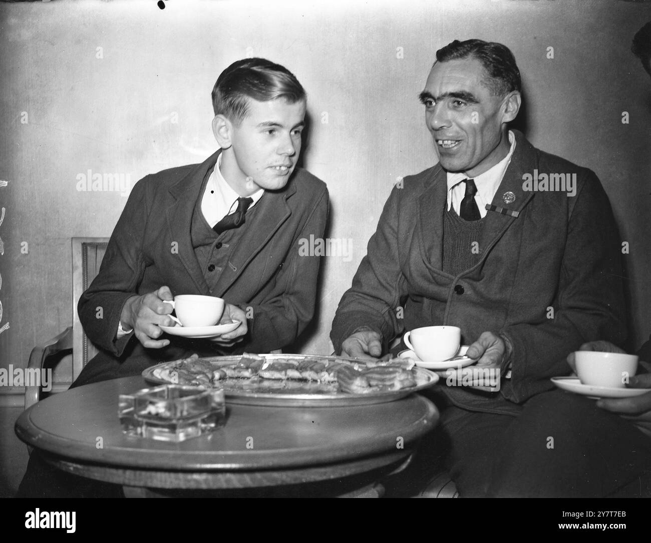 NOT FORGOTTEN” ASSOCIATION ENTERTAINS BRITISH WOUNDED DECEMBER 1944 The Princess Royal was present when the “Not Forgotten” Association entertained British wounded from the Queen Mary Roehampton Hospital at a cabaret tea in the Dorchester Hotel, London, in aid of the Association’s funds. PHOTO SHOWS:- SPHOTO SHOWS:- Pte. Arthur Coldman (left) aged 18, of Putney, South-West London, whose right arm was wounded by shrapnel when he was serving in Holland with the Welch Regiment, talking with Company Sergeant-Major Albert Langley, D.C.M. of the King’s Royal Rifles, who has served 22 of his 44 years Stock Photo