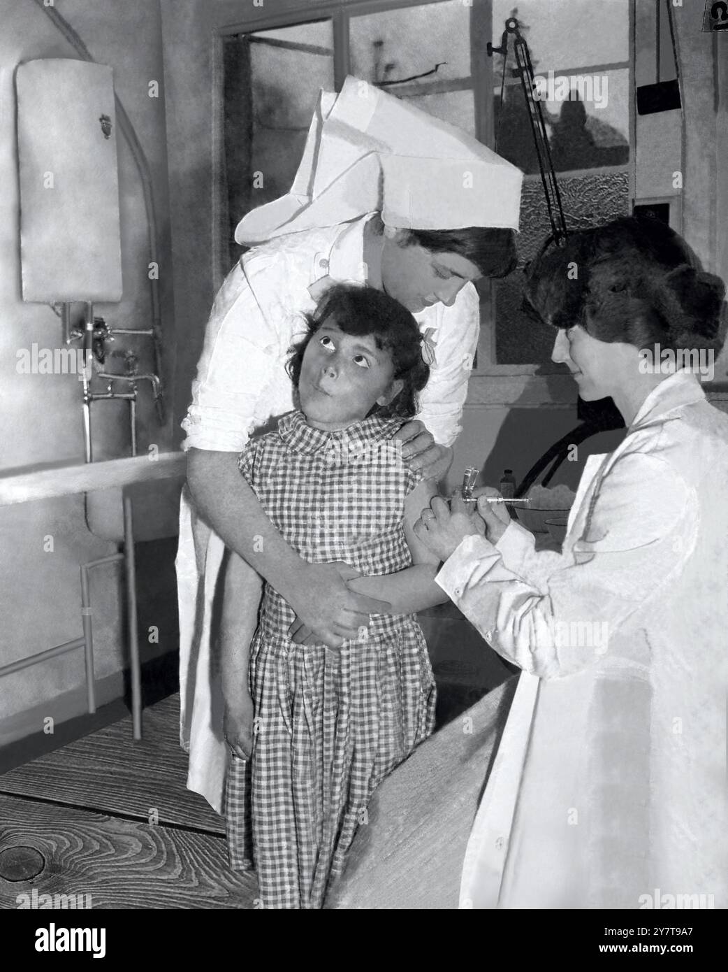 ANTI-POLIO VACCINATION IN SOUTHAMPTON Southampton : Seven year old Maureen Doak, of Schooling, Southampton, looks wistful as she gets her first shot of the new polio vaccine from Dr Catherine Atkins at the Sydney House Clinic in Southampton. Holding Maureen is nurse Margaret Emery, of Highfield.  7 May 1956 Stock Photo
