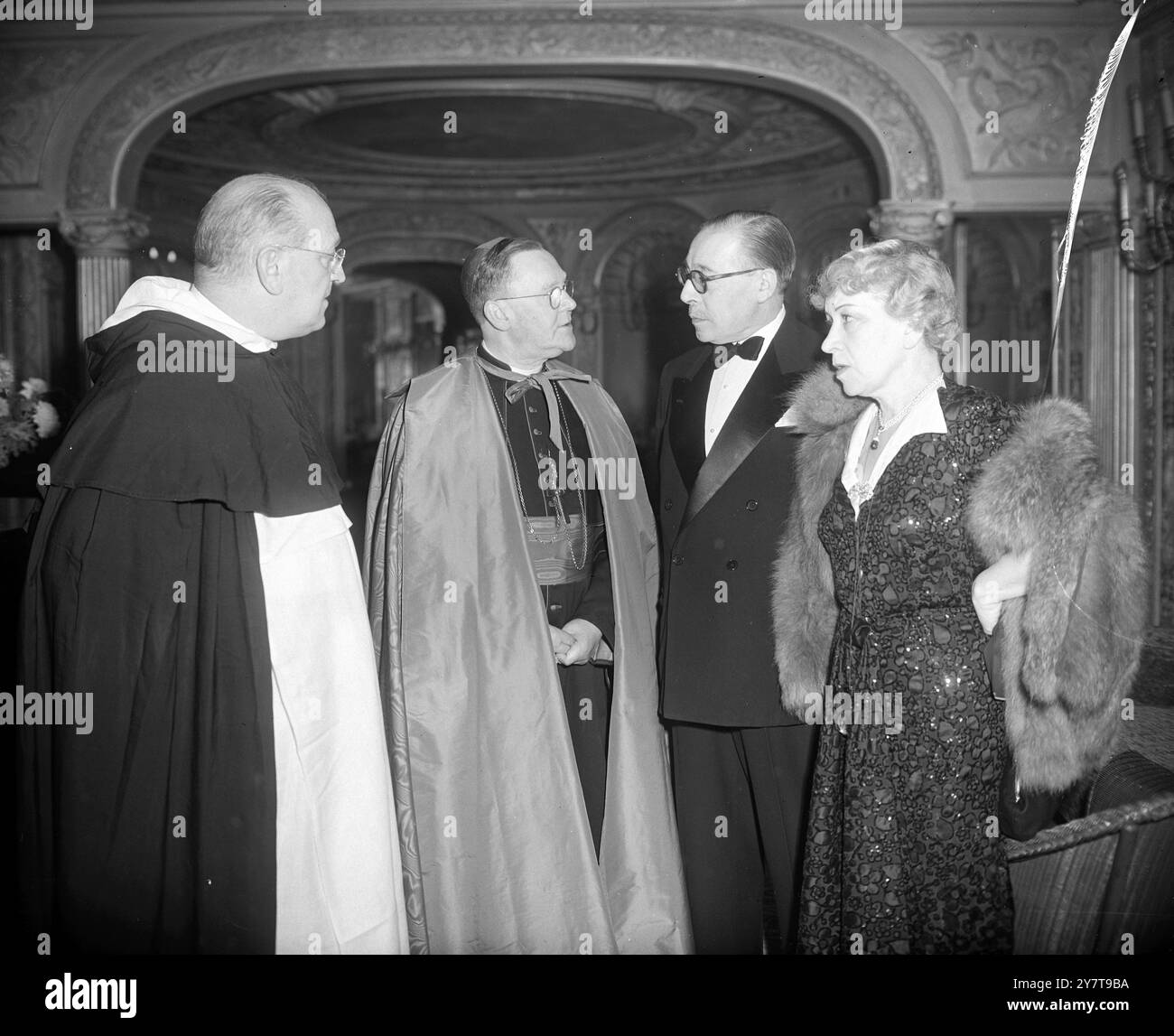 CATHOLIC FILM PREMIERE   Archbishop William Godfrey, Apostolic delegates to Great Britain, at the Palace Theatre, Cambridge Circus, London, in conversation with Dr RUY ENES ULRICH , the Portuguese Ambassador in London , and SENHORA ULRICH (on right) were received, as guests of honour, by the Archbishop at the premiere of the film ' Pilgrimage to Fatima '. On left is the Very Rev Father Hillary Carpenter, O.P., chairman of the Catholic Film Institute. ' Pilgrimage to Fatima' was produced by the Catholic Film Institute with funds donated by over 11,000 Catholics in Britain and Ireland.    24 Oct Stock Photo