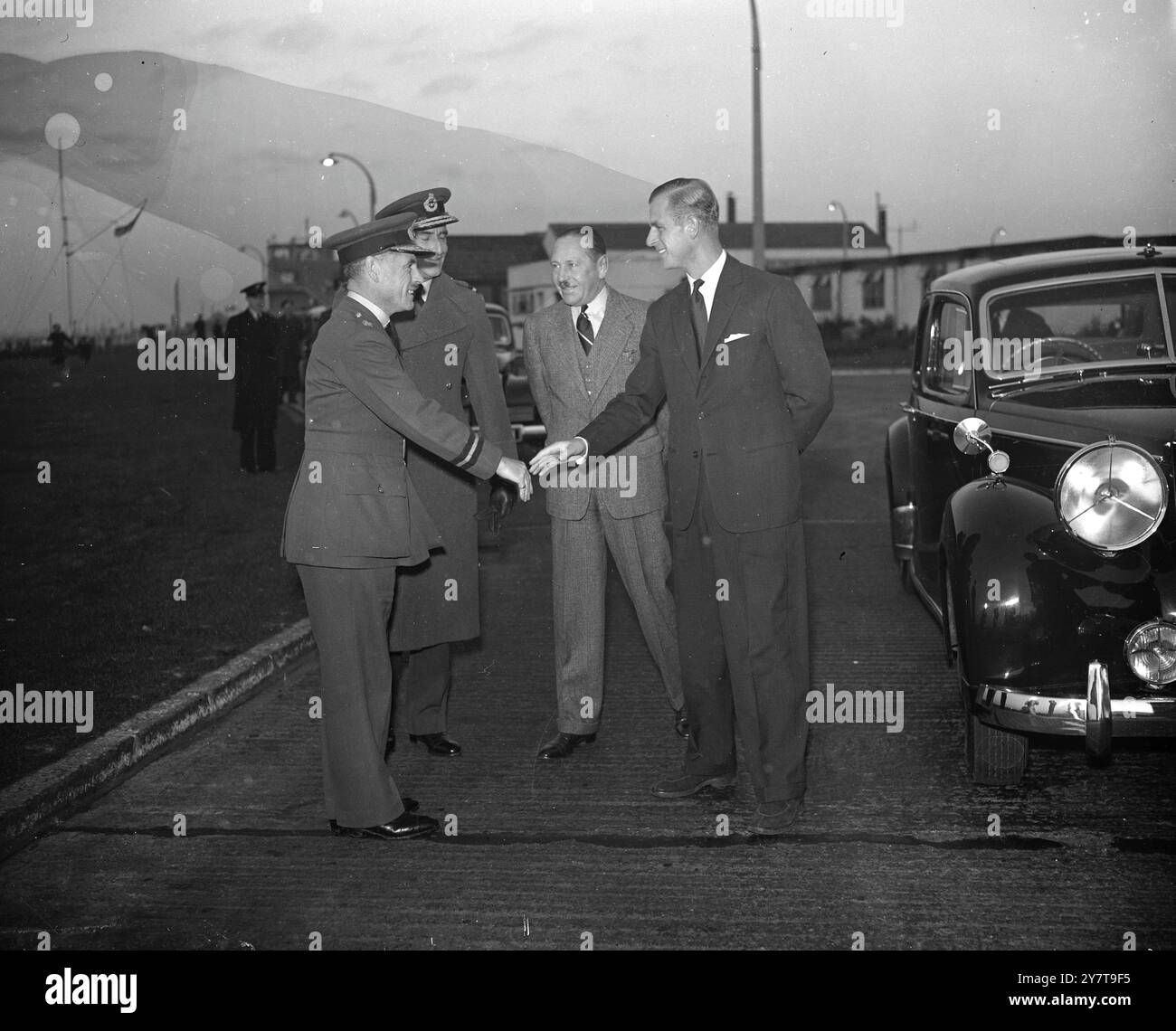 DUKE OF EDINBURGH RETURNS TO DUTY - The Duke of Edinburgh , who flew home from the Mediterranean to attend the Christening of his baby daughter , Princess Anne , left London Airport to return to duty in command of the frigate ' Magpie ' . The Duke is pictured shaking hands with Air Marshal Fielden , Master of the King's Flight , upon his arrival at London Airport early today . In civilian clothes is Sir John D'Albiac the Airport Commander .  26 October 1950 Stock Photo