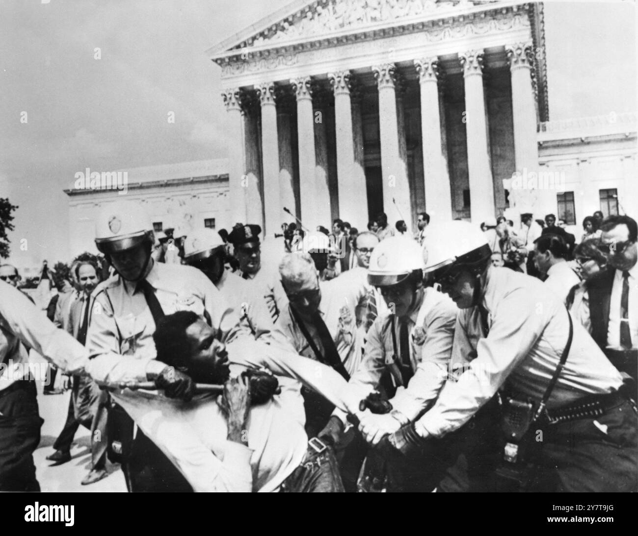 POOR PEOPLES' PROTESTWASHINGTON: RAY ROBINSON of Chicago, a member of the Poor Peoples' Campaign, is hauled away from the front of the U. S. Supreme Court by police yesterday. He violently resisted and it took a half a dozen Washington policemen to subdue him. 30 May 1968 Stock Photo