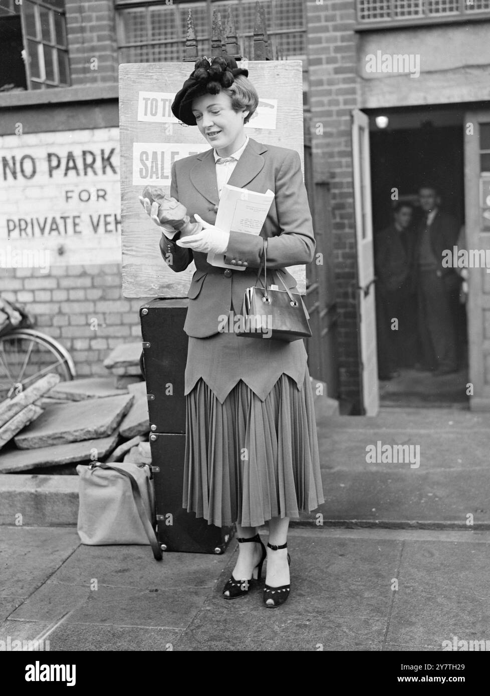 KNOCKED DOWN TO PHYLLIS CALVERT ,  Film actress Phyllis Calvert, one of the many famous stars who have worked at Shepherd's Bush (London) film studios, with a memento of her career- a bust of the composer Liszt used in ' The Magic Bow ' -which she bought at the studio today. The sale by auction of the contents of the studios (closed down owing to the crisis in the film industry) began today will continue to November 3. During the sale 2, 619 lots, closely associated with the history of British films will come under the hammer. With Calvert , whose costume has a novel skirt combining points and Stock Photo