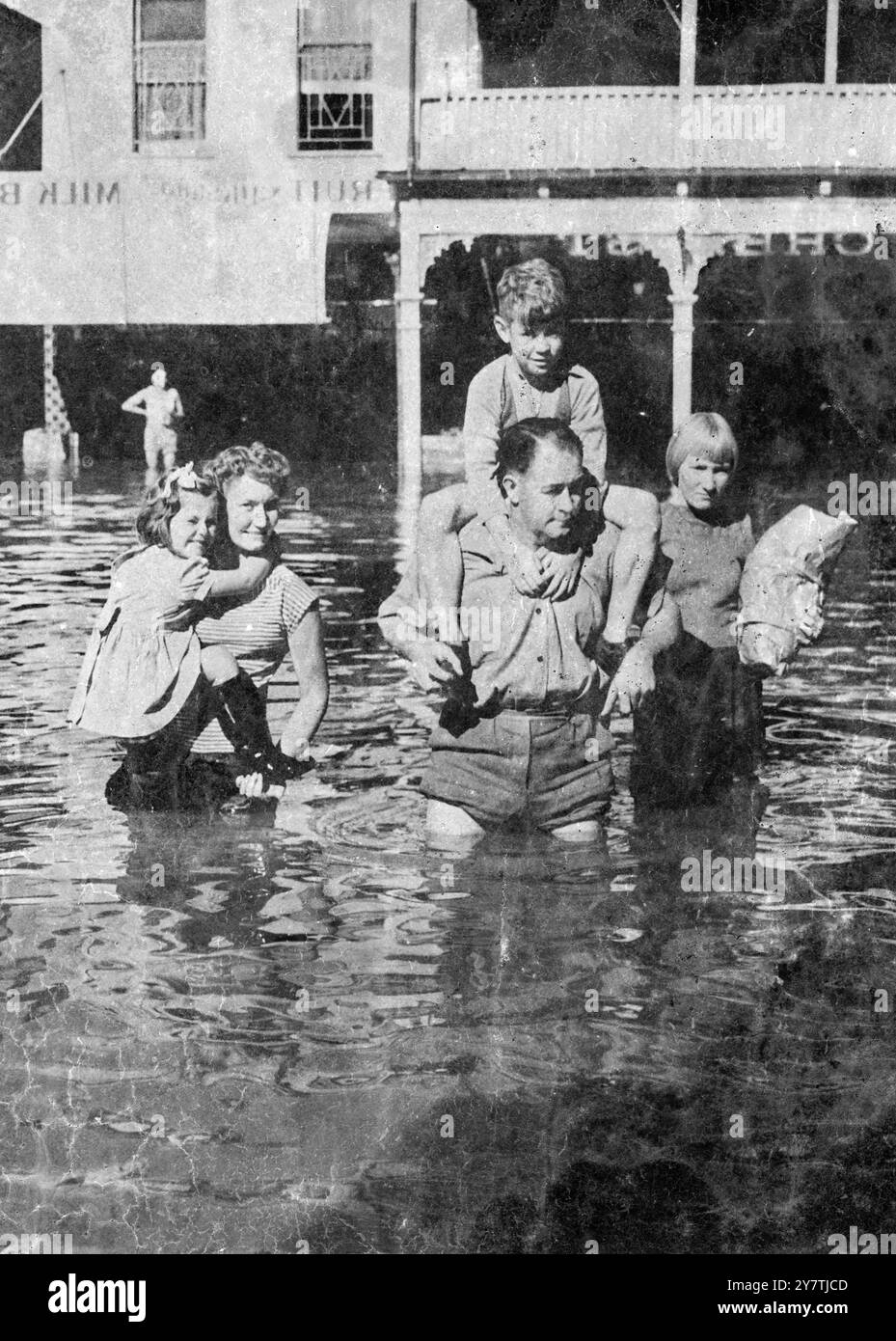 Floods in New South Wales , AustraliaWagga Wagga :  A family retreats to safety through the rising floodwaters in this New South Wales town.  Heavy rains continue in the area , and several rivers and creeks have burst their banks.  In all a large area is under water in Central New South Wales , crops have been ruined and one man has been drowned and another feared lost 3 April 1950 Stock Photo