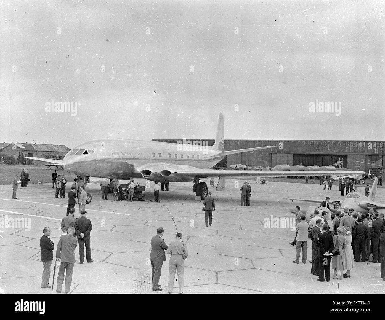 Hatfield  , England :  The De Havilland Aircraft Company 's ' Comet ' jet-propelled airliner - in which there is hope of retrieving the leeway lost in the war when Britain concentrated on combat aircraft - is wheeled out of the factory here for the first time.  This latest experiment in aviation history - the Comet - being the only fully-jet airliner in the world - is powered by four de Havilland ' Ghost ' jet engines , and it is expected to cruise at almost 500 miles an hour - the London-Sydney journey , for instance , will take 36 hours.  The plane , carrying 36 passengers and a crew of four Stock Photo