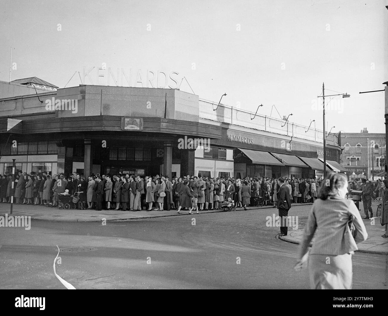All night queue for ' off the ration ' carpets and pyjamasA queue of hundreds of people , some of whom had waited all night , stretched along three sides of Kennard's department store , Wimbledon , in the hope of buying no-docket carpets and rugs and coupon-free Government surplus pyjamas when the store opened .  Photo shows:  The long queue outside the store 30 September 1946 Stock Photo