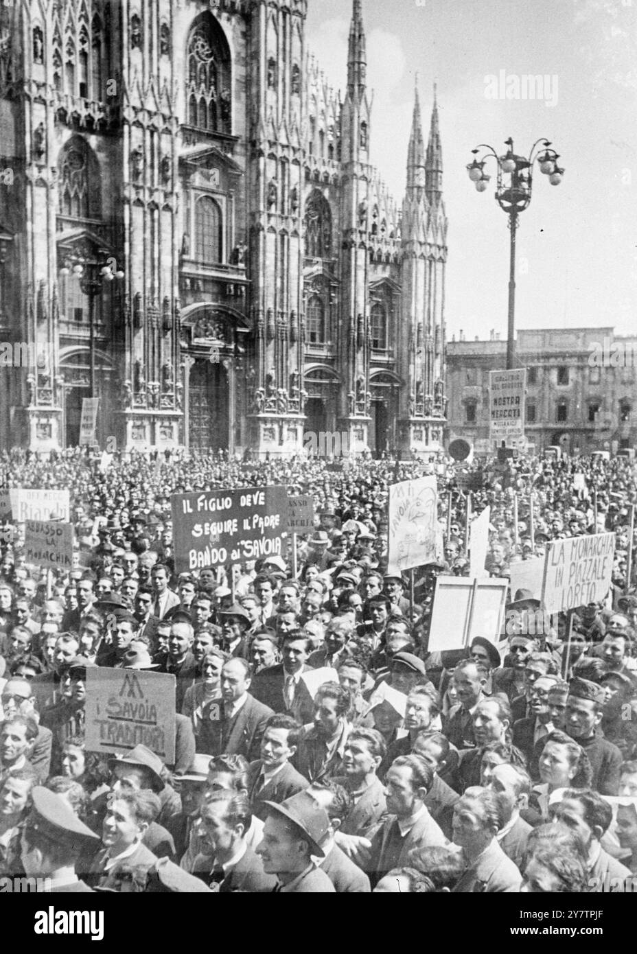 ANTI MONARCHIST DEMONSTRATIONS IN MILAN With the abdication of King Victor Emmanuel of Italy in favour of his son, now styled King Umberto II (but not by the grace of God and the will of the people) feelings are running high in Italy.  In Milan, spontaneous demonstratins against the monarchy and the House of Savoy have broken out in noisy gatherings and processions in the streets and squares of the city. Photo Shows: Anti monarchits demonstrators in the main square in Milan, Italy assemble with slogans and banners. 1946 Stock Photo