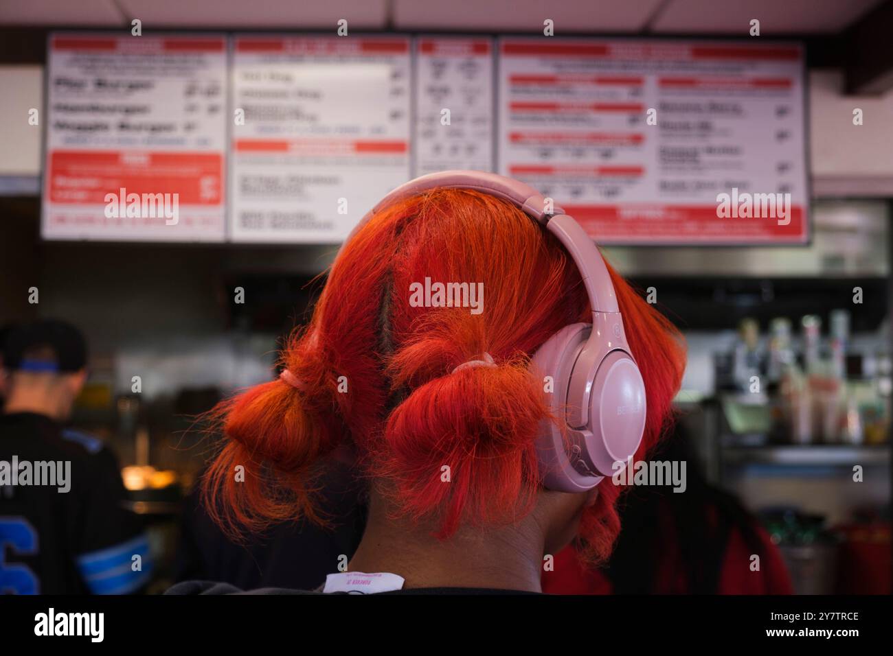 Red hair and pink headphones, Santa Monica Pier, Los Angeles, California, United States of America Stock Photo
