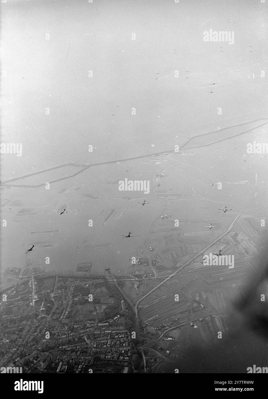 Britain sees reinforcements on their way to HollandMany people in Britain were able to see the great formations of airborne troops and supplies passing on their  way to reinforce the Allied airborne army already landed in Holland.  Photo shows:  Part of a big air formation of transports and gliders crossing the English countryside on their way to Holland 19 September 1944 Stock Photo