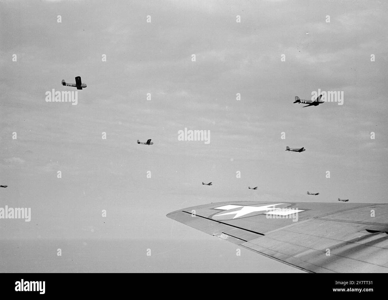 Britain sees reinforcements on their way to HollandMany people in Britain were able to see the great formations of airborne troops and supplies passing on their  way to reinforce the Allied airborne army already landed in Holland.  Photo shows:  Part of a big air formation of transports and gliders crossing the English countryside on their way to Holland 19 September 1944 Stock Photo