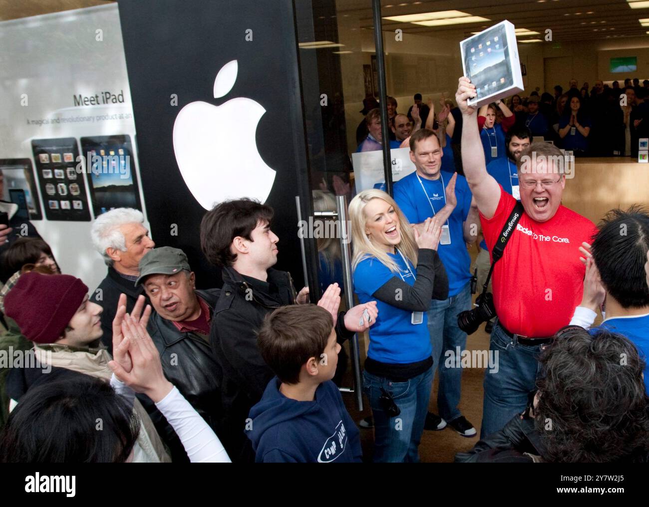 Palo Alto, California - April 3, 2010 Man walking out of Apple store holding up his new ipad. He started waiting on line at 11AM on Friday, April 2, 2010 to be the first in Palo Alto to own a new IPad. Stock Photo