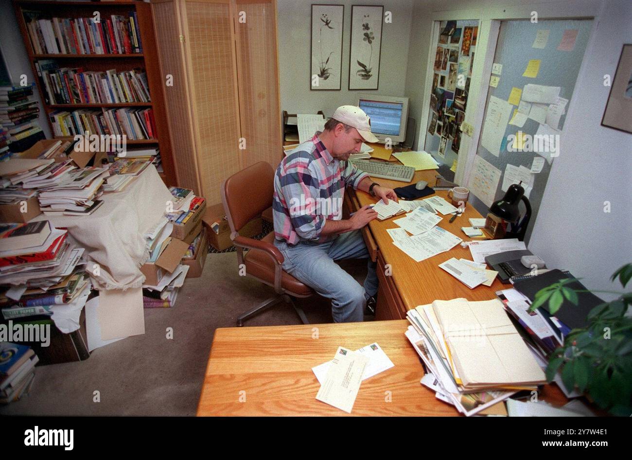 Jim Forthoffer a high school math teacher at Mountain View High School pays bills inside his mobile home in Palo Alto, Calif., where he has lived for the past ten years. Forthoffer is a Stanford University graduate who can only afford the rent on a mobile home. Even buying an apartment in the area is out of the question on a teacher's salary.  Photo: Stock Photo