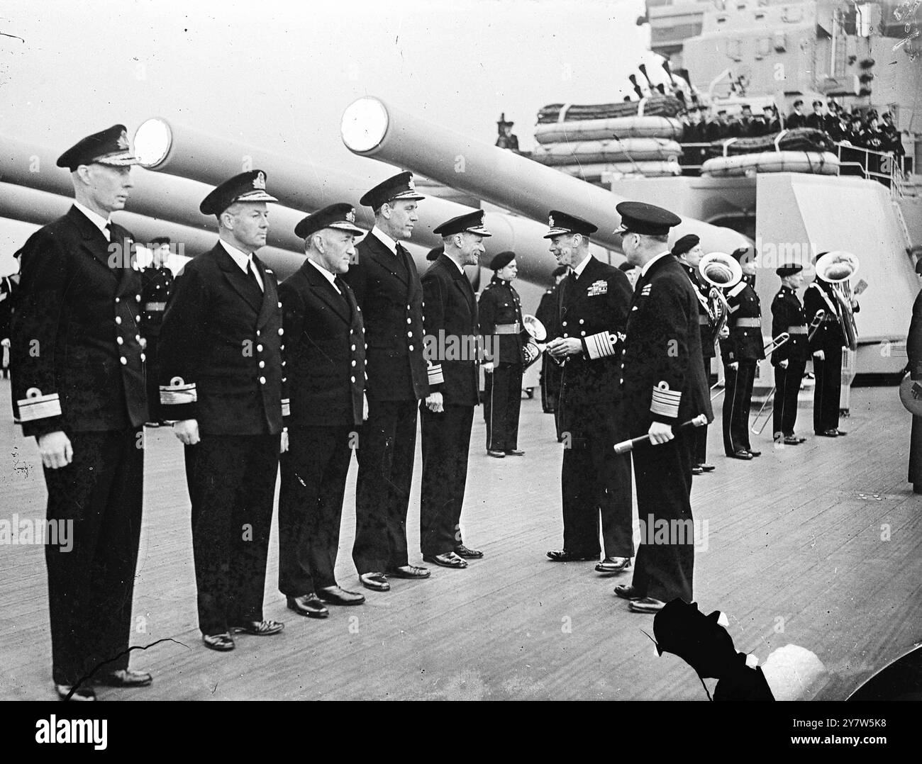 THE KING WITH THE HOME FLEET During the recent visit of HM the King George VI to the Home Fleet he witnessed a dummy attack on a submarine and later met airmen. Photo Shows:The C in C Admiral Sir Bruce Fraser introducing his Flag Officers to the King.  They are (right to left)  Vice Admiral Sir H R Moore, K C B, D V O, D S O, Rear Admiral F H G Dalrymple-Hamilton C B, Rear Admiral R R McGrigor C B, D S O, Rear Admiral A W La T Bissott, and Commordore W R Slayter D S C May 1944 Stock Photo