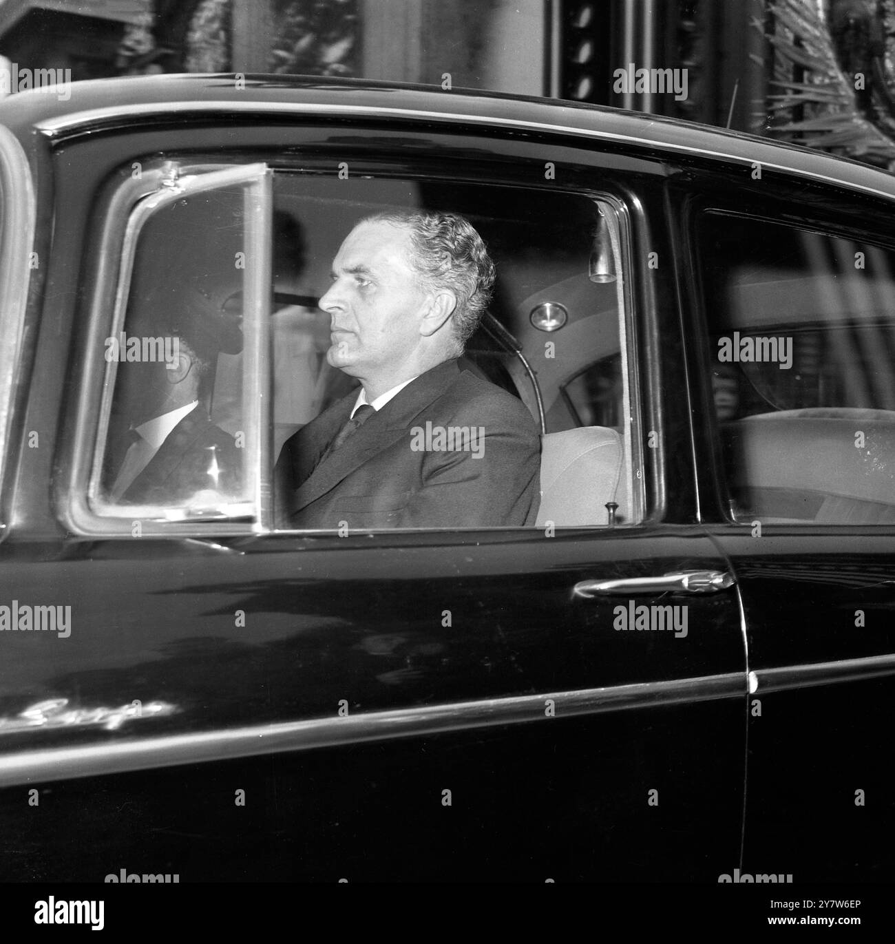 Mr Timothy Bligh, Principal Private Secretary to Prime Minister Macmillan, pictured as he was driving from Buckingham Palace this morning. Shortly after Mr Bligh's visit to the Palace, it was announced that Mr Macmillan had tendered his resignation to the Queen, London, England.18 October 1963 Stock Photo