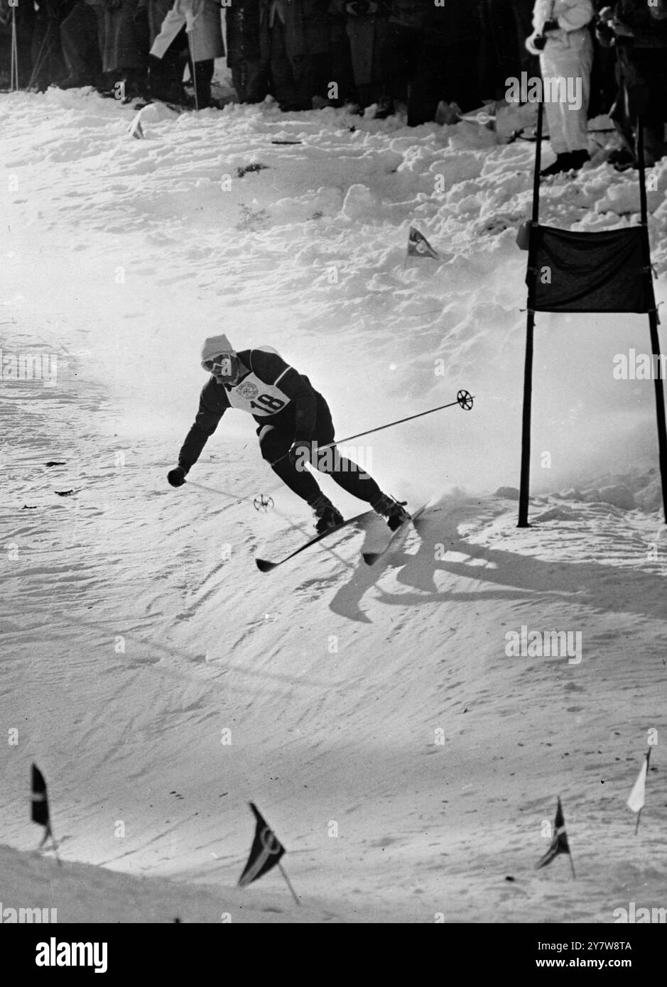 In the astounding time of 3 minutes and 1 tenth of a second, Austrian skier Anton Sailer swerves a gate in the snow as he wins the Men's Giant Slalom event at the seventh Winter Olympic Games in Cortina D'Ampezzo in the Italian Alps.31 January 1956 Stock Photo