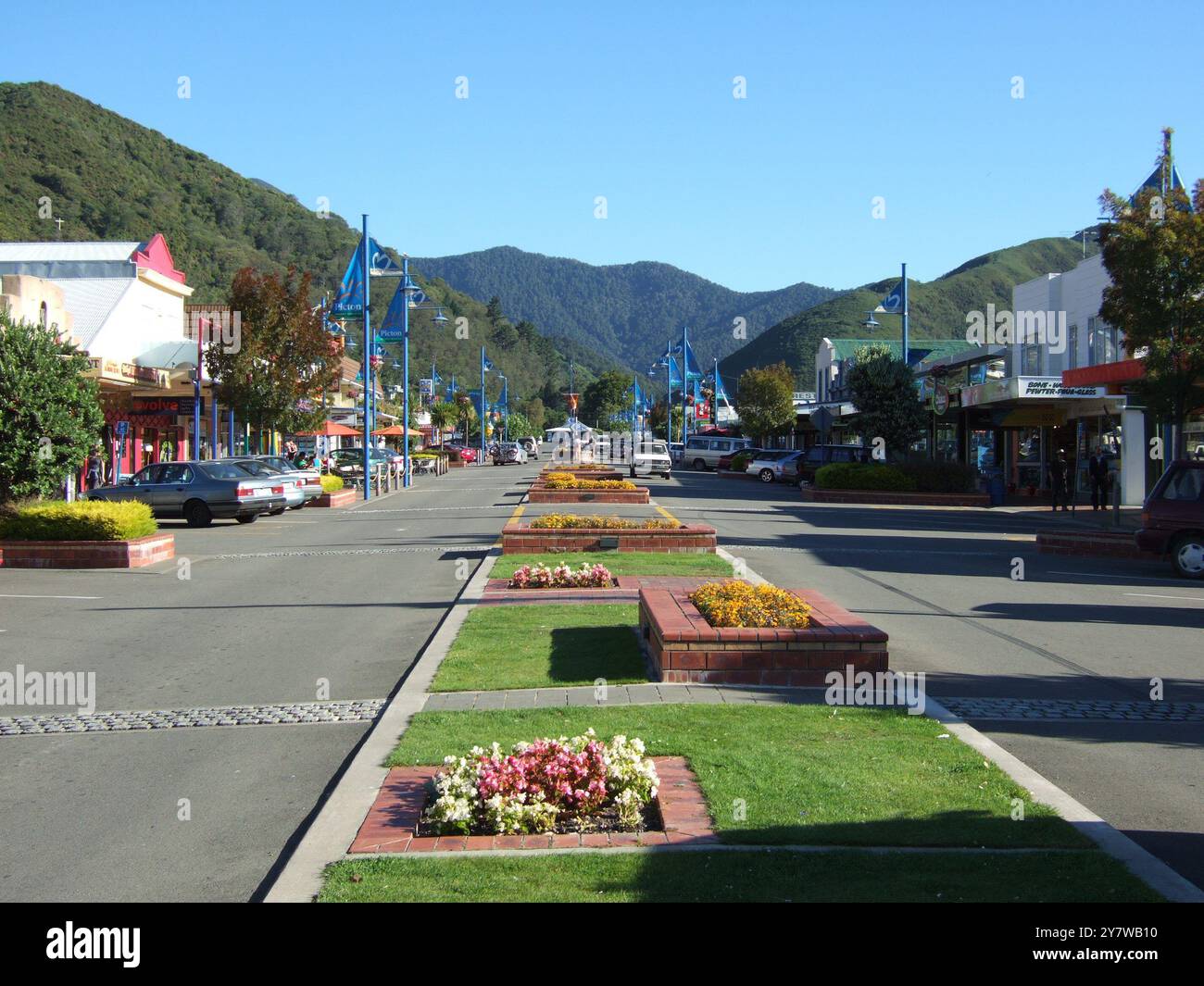 Flower beds down centre of roadway in Picton Picton, South Island, New Zealand - 2006  Picton / The Marlborough Sounds of New Zealand.  Picton is a small seaport at the head of the Queen Charlotte Sound offering a relaxed setting with beautiful beaches, easy bush walks and an outstanding climate.  The Marlborough Sounds is renowned for its 1500 km of coastline, The Queen Charlotte Track, Dolphin Watching, fishing and a peaceful retreat.  Daily ferry services link Picton to Wellington, the capital of New Zealand, situated at the southern end of the North Island.  ©2006 Credit:TopFoto / AMS Stock Photo