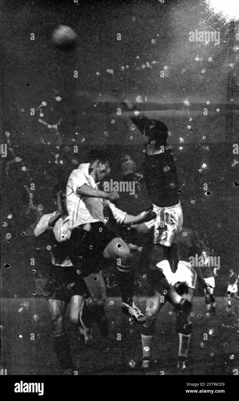 The Manchester United goalkeeper , Harry Gregg , leaps up and punches the ball clear from a dangerous attack on the Manchester goal by the Feyenoord forwards during their friendly match in Rotterdam this evening . Manchester United arrived by air - the first time flying since the disasterous air crash in Minuch - last weekend to commence their out of season tour , Rotterdam , Holland .28 April 1959 Stock Photo