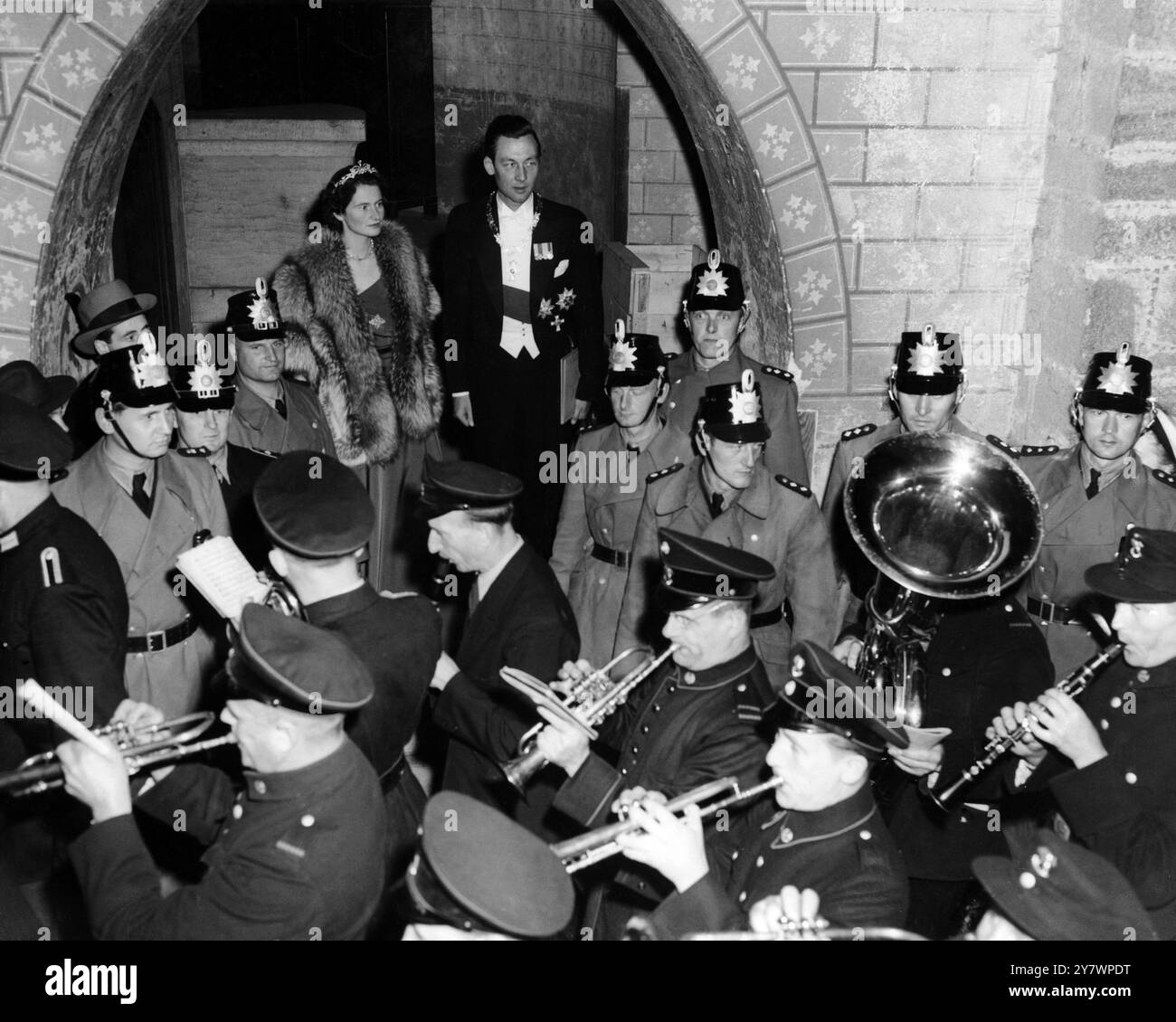 The band provides music for the crowd's 'serenade' of the banned first verse of Deustschland uber Alles , in honour of Prince Ernst August of Hanover and his bride Princess Ortrud of Schleswig-Holstein-Gluckburg at Marienburg castle when some 4,000 local well-wishers stages a torchlight parade . The procession tookplace on the eve of the pair's church wedding at Hanover . They were married at a civil ceremony held at the Castle - - 5th September 1951 Stock Photo