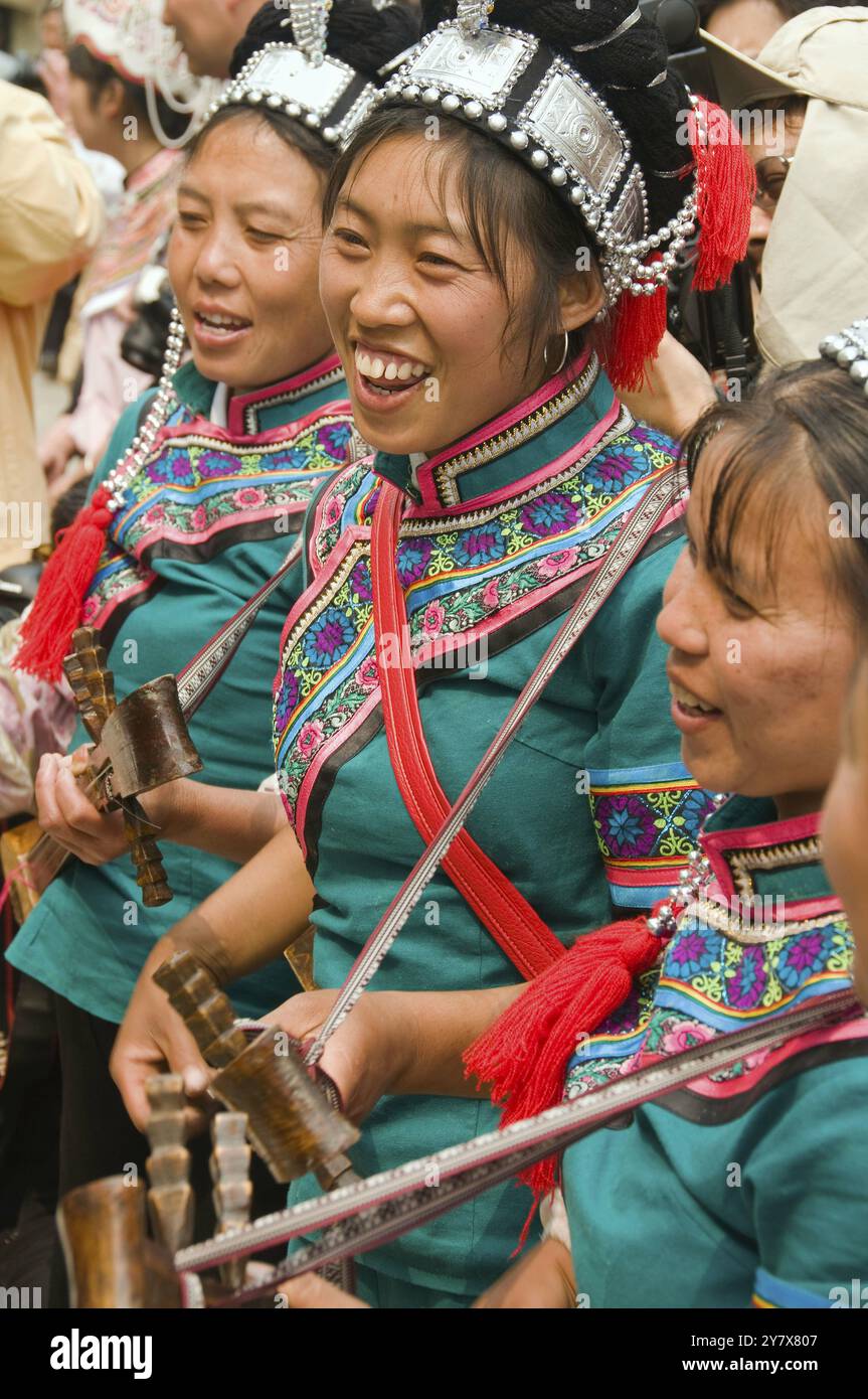 Hani women playing local instruments at the Long Table Festival in Yuanyang China Stock Photo