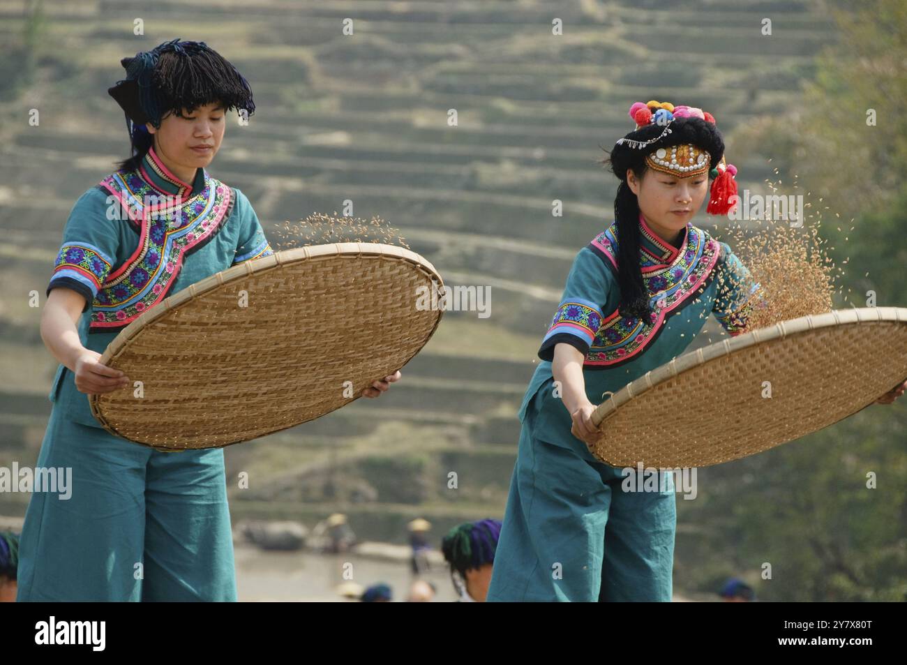 Hani Akha women sifting rice at a festival in Yuanyang China Stock Photo