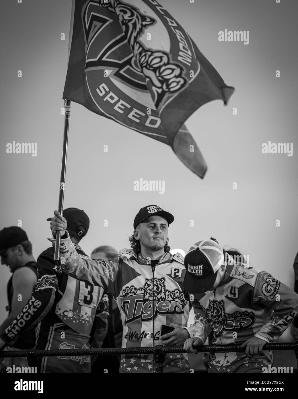 Glasgow Tigers Speedway Rider, Jack Smith, Makes A Defiant Flag Raising Gesture Whilst Celebrating A Team Win With Team Mates. Stock Photo