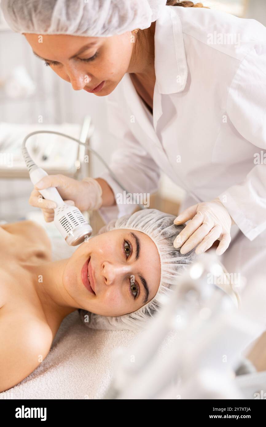 Female patient receiving hardware facial procedure using cooling ...