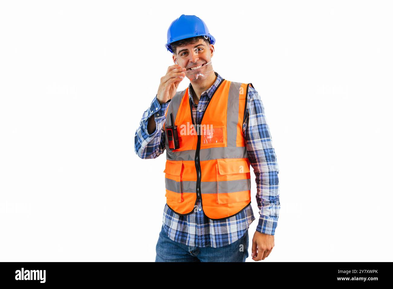 construction worker wearing an orange reflective vest and a blue helmet ...