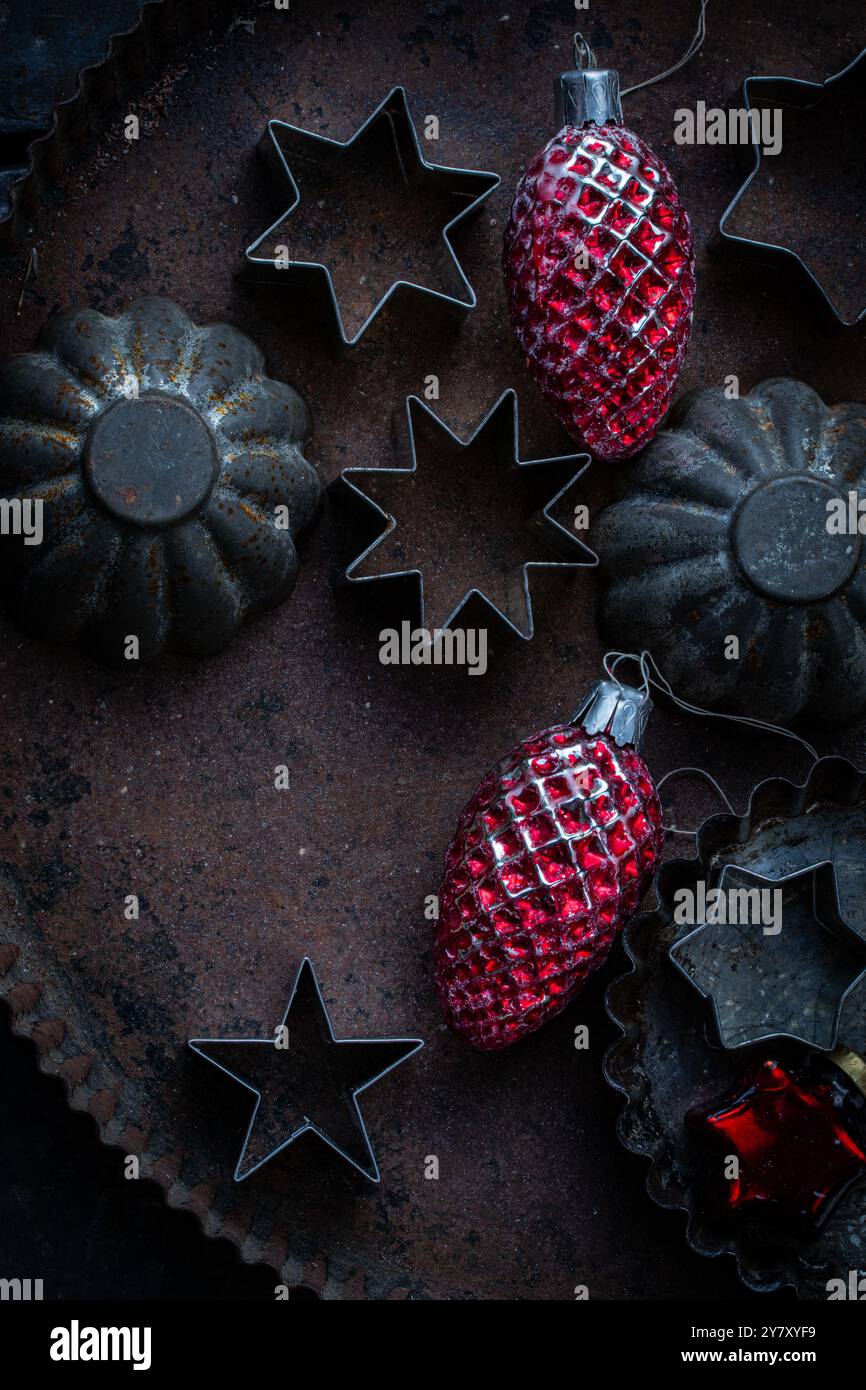 Old cookie cutters on tin with old Christmas tree decorations Stock Photo