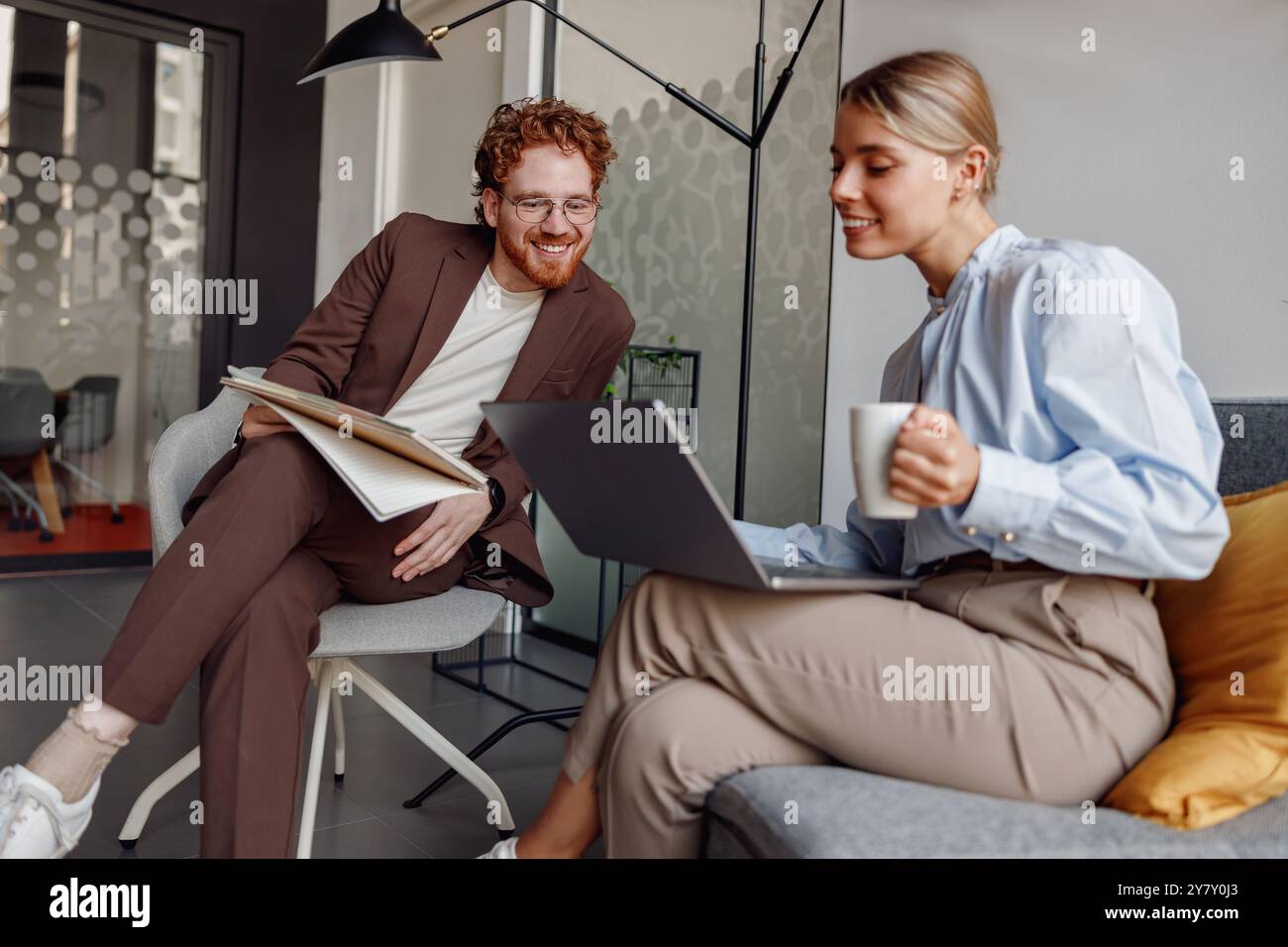 Engaging in Collaborative Work within a Modern Office Environment for Enhanced Productivity Stock Photo