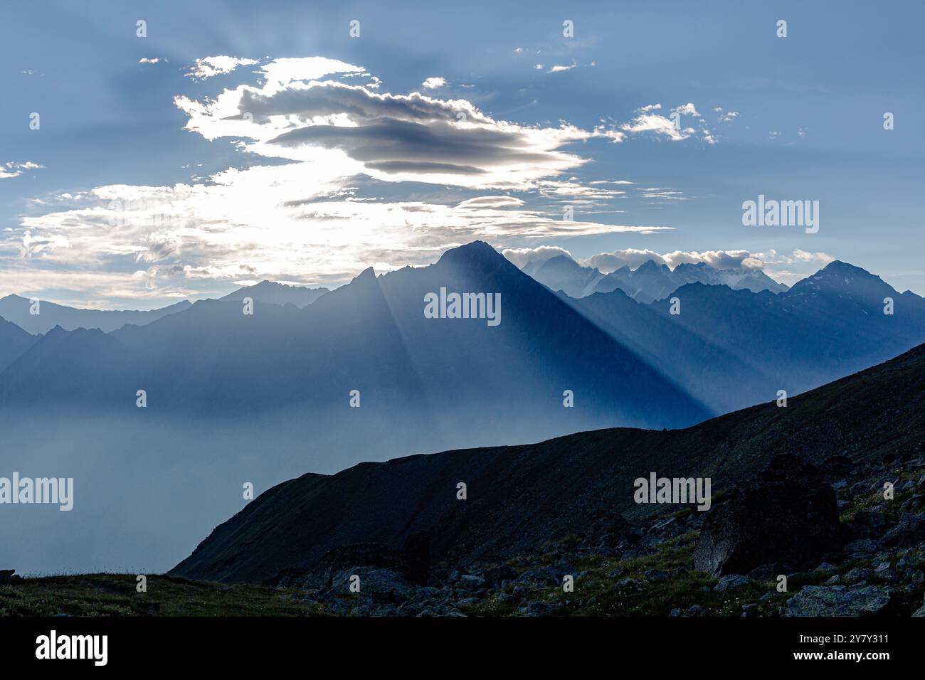 A breathtaking panorama of rugged peaks, bathed in the golden light of ...