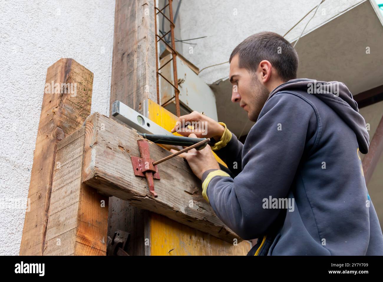 Worker is installing and assembling column formworks for concrete ...
