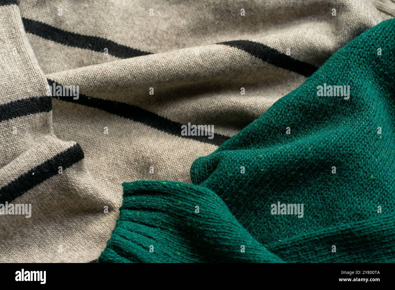 Two hand knitted wool sweaters. Background textures. Stock Photo