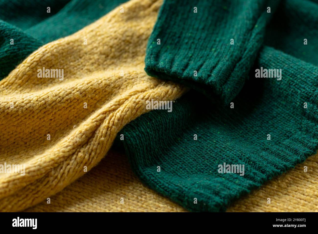 Two hand knitted wool sweaters. Background textures. Stock Photo