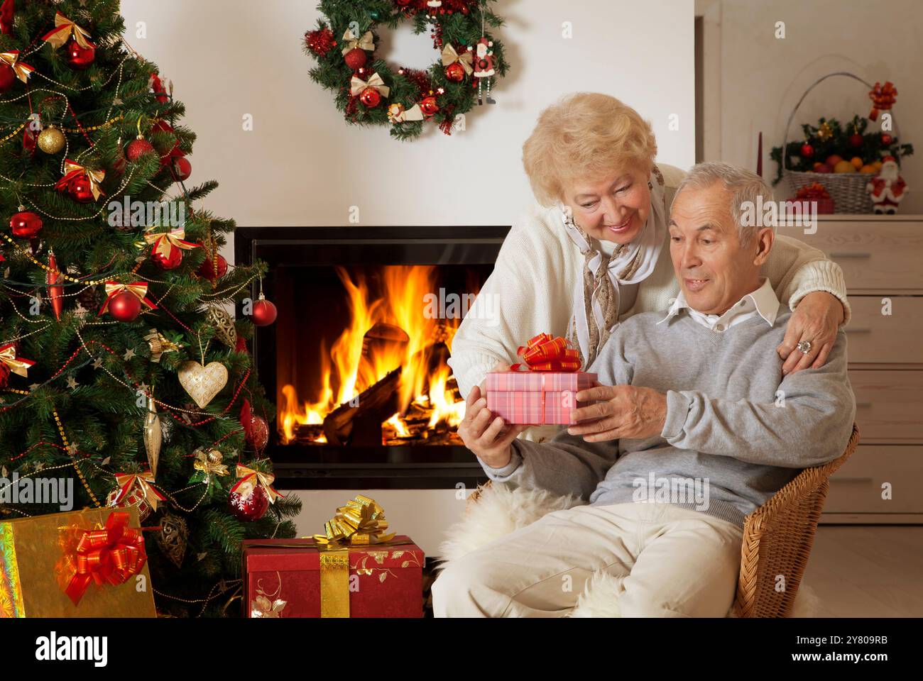 Happy senior man getting Christmas present, satisfied Stock Photo