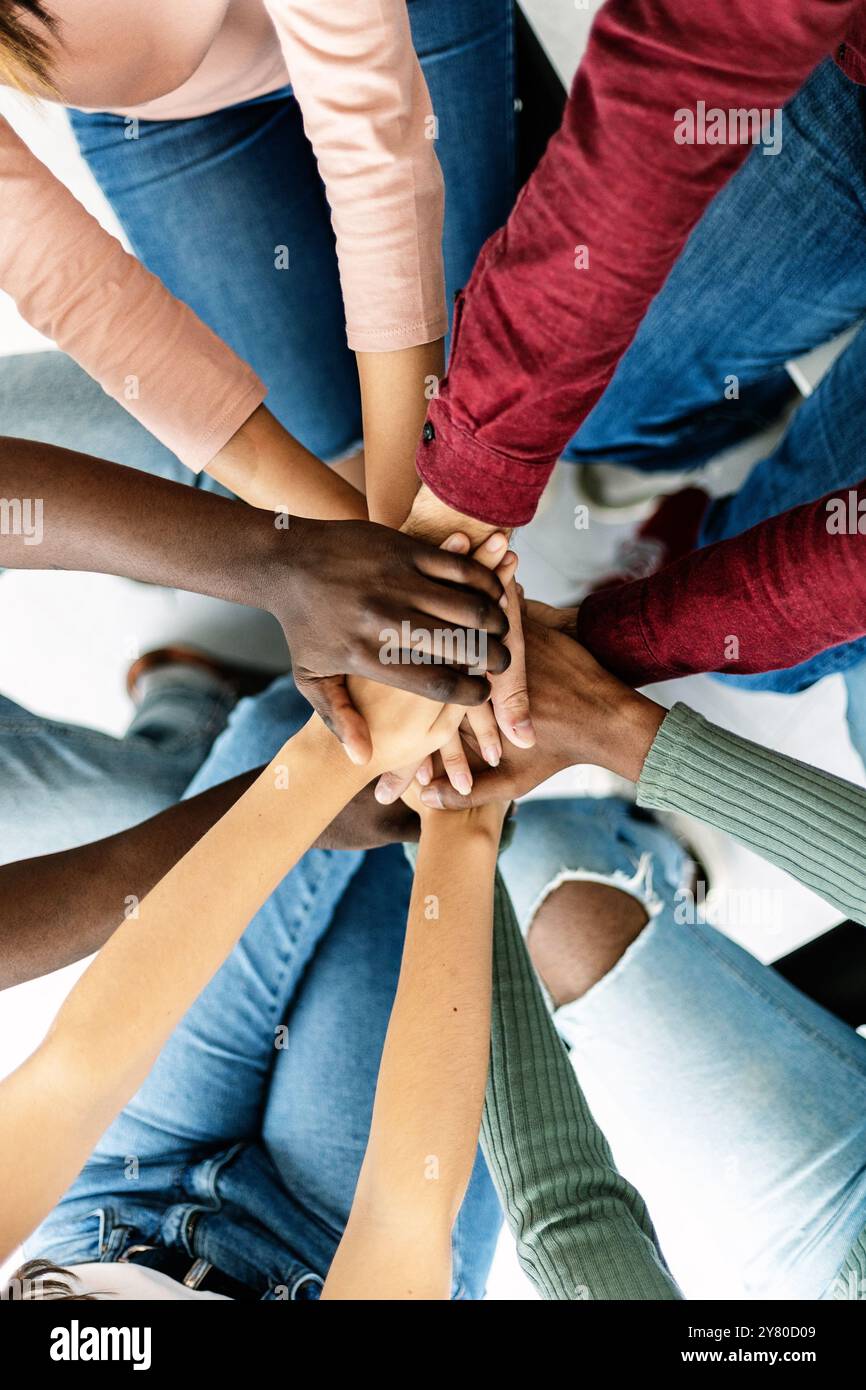 Young group of diverse people stacking hands Stock Photo