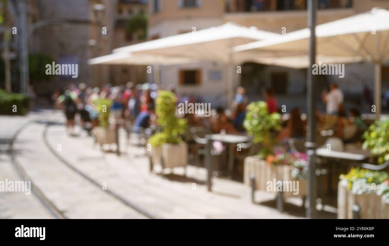 Outdoor cafe scene in mallorca with blurred people and defocused ...