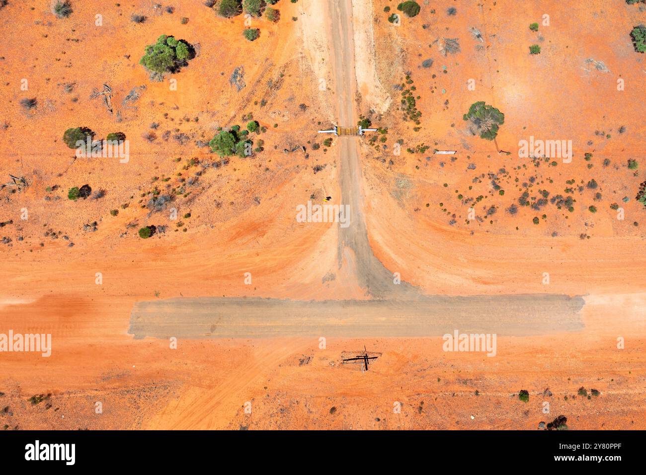 Aerial view of a T intersectionand gateway in a barren outback landscape near Broken Hill In Outback New South Wales, Australia. Stock Photo