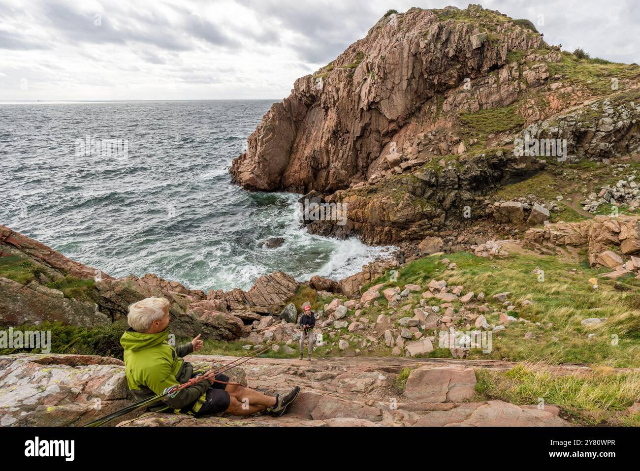 You can practise abseiling on the rugged rocks of the Kullaberg peninsula under the guidance of a guide. Italienska vägen, Mölle, Skåne län, Sweden Stock Photo