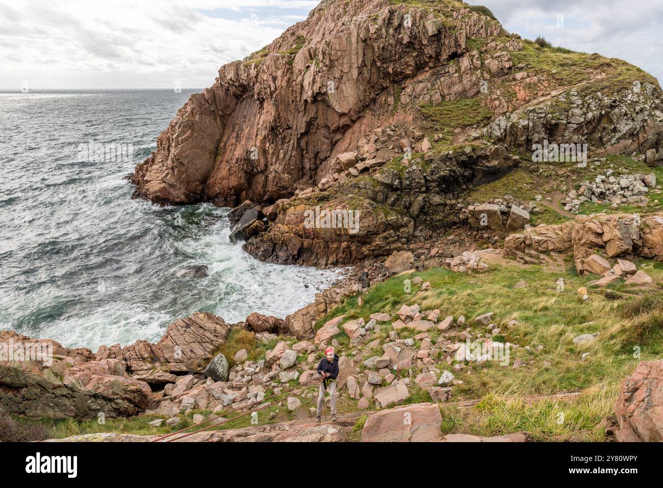 You can practise abseiling on the rugged rocks of the Kullaberg peninsula under the guidance of a guide. Italienska vägen, Mölle, Skåne län, Sweden Stock Photo