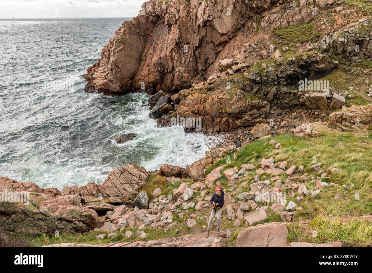 You can practise abseiling on the rugged rocks of the Kullaberg peninsula under the guidance of a guide. Italienska vägen, Mölle, Skåne län, Sweden Stock Photo