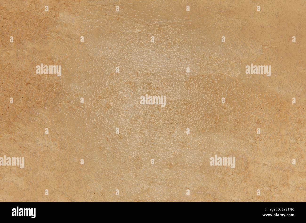 The background texture is a rough brown glossy surface with streaks and ...