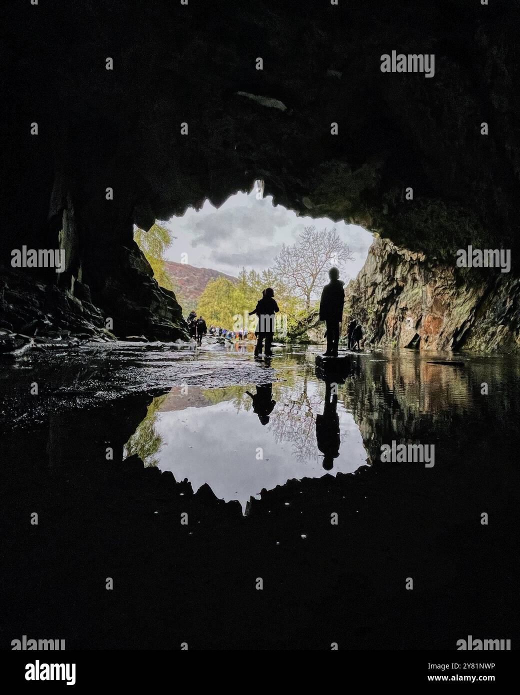 Silhouettes of people inside, Rydal Cave, on the North side of Loughrigg Fell, Ambleside in the Lake District. - Smartphone Captured Stock Image