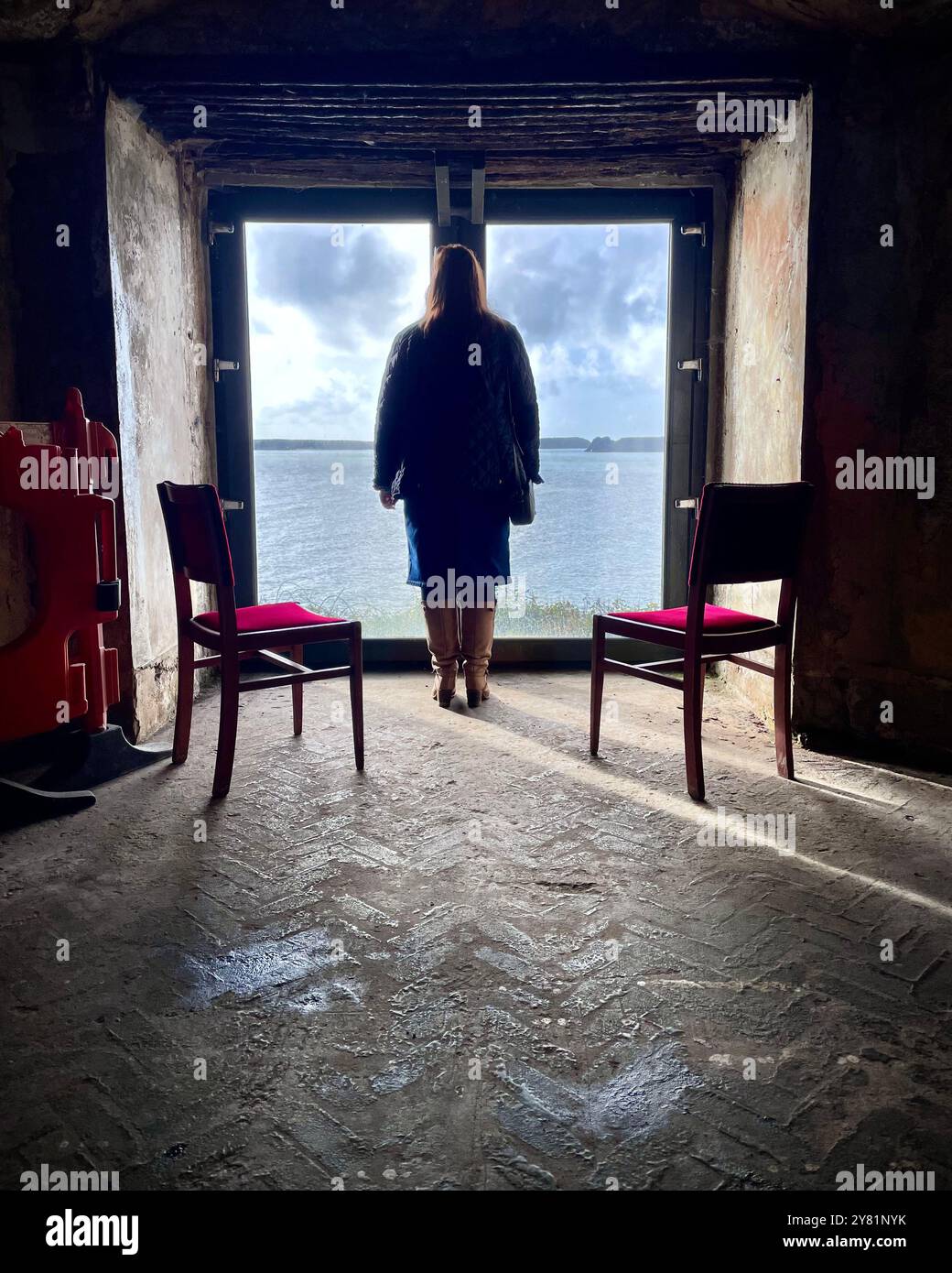 Eerie woman standing at window - Smartphone Captured Stock Image