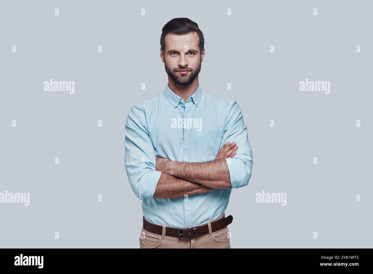 Perfect man. Handsome young man looking at camera and smiling while ...