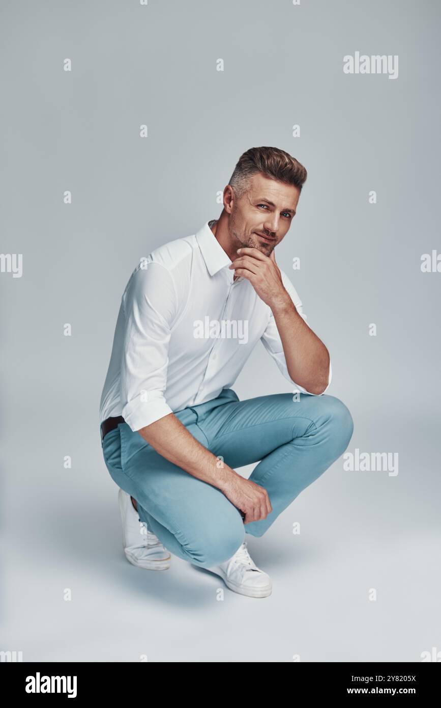 Male beauty. Handsome young man looking at camera and smiling while ...