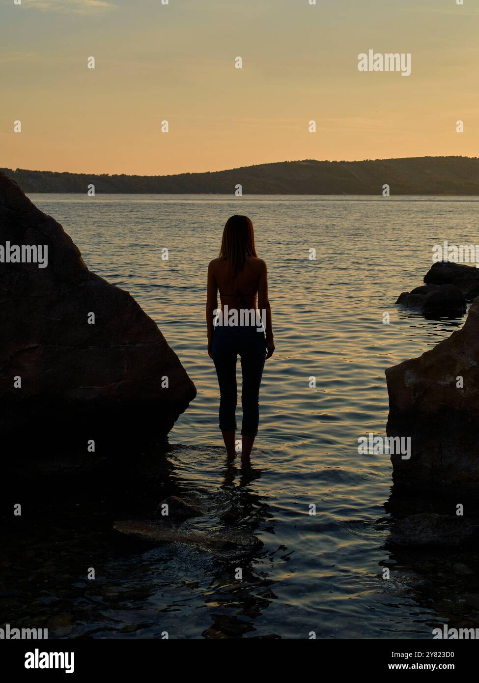 Woman standing at rocks hi-res stock photography and images - Alamy