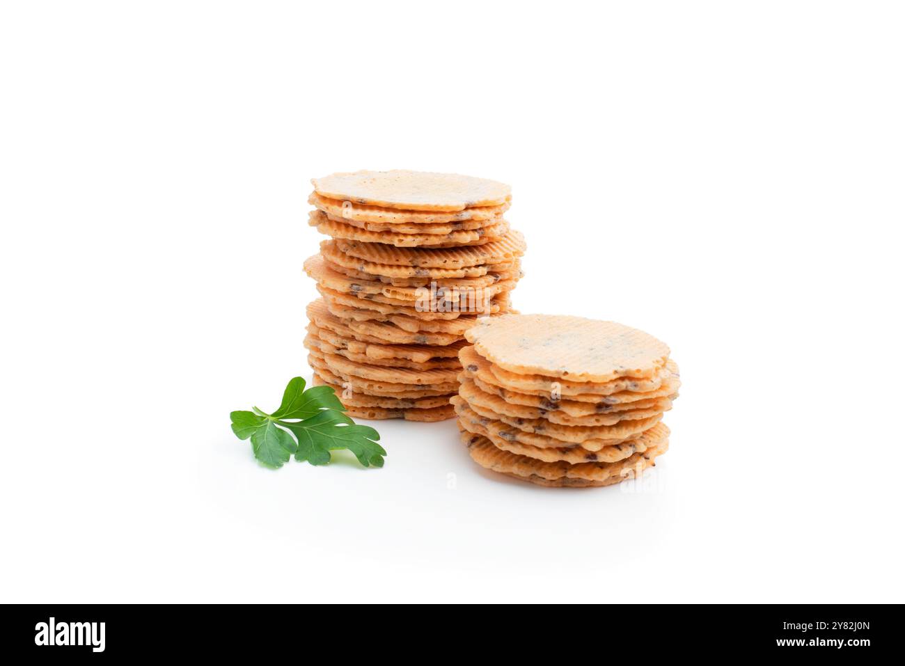Stack  of thin round crispbreads with herbs isolated on white Stock Photo