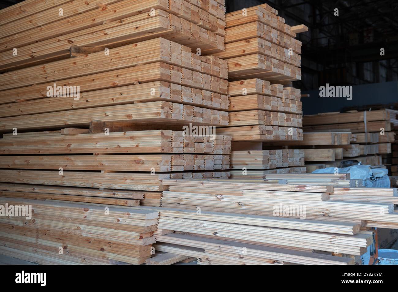 Stacked wooden planks close-up at lumber warehouse. Wood industry ...